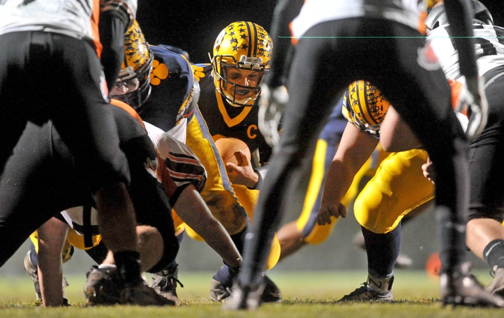 Mt. Blue High School quarterback Ryan Pratt holds on to the ball as he goes for a sneak into the end zone during a game against Brunswick on Oct. 16. The Two teams will meet Friday in a Pine Tree Conference Class B semifinal game in Brunswick.