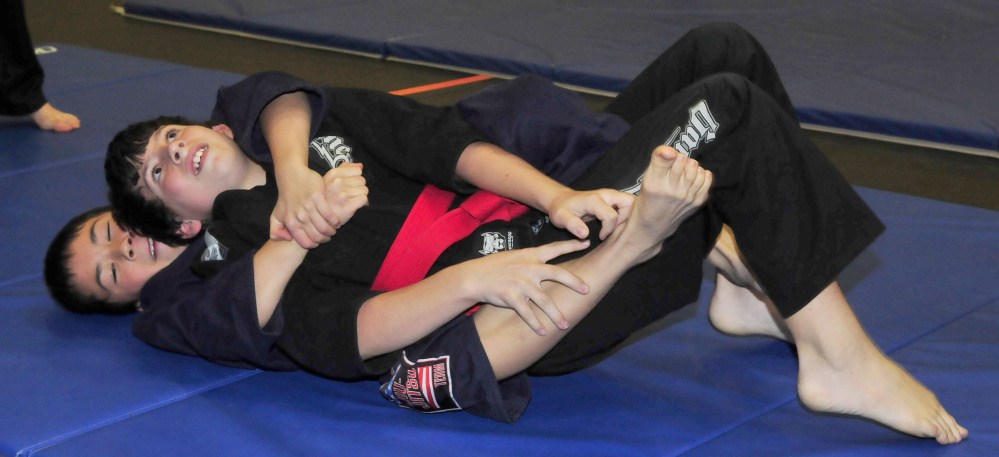 Ryan Yang, bottom, and Riley Cotter compete in the annual Maine Skirmish event Sunday in Winslow.