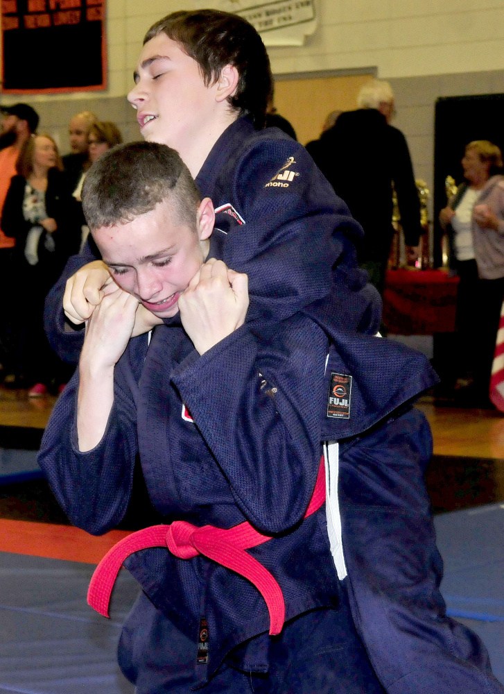 Nick Bradley, top, has a firm hold on Mackenzie Huard during Maine Skirmish event Sunday in Winslow.