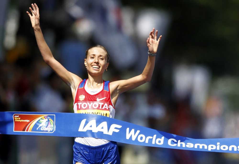 In this Aug. 31, 2011 file photo Russia’s Olga Kaniskina reacts as she crosses the finish line to win the Women’s 20km Race Walk at the World Athletics Championships in Daegu, South Korea.