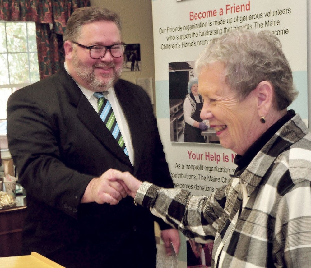 Maine Children’s Home for Little Wanderers Executive Director Sharon Abrams congratulates Richard Dorian after the announcement that he will become the new director at the Waterville nonprofit organization on Tuesday. Abrams will retire at the end of the year.