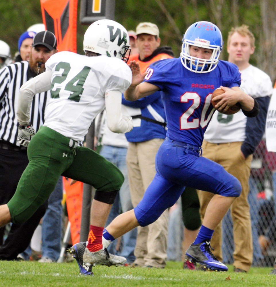 Winthrop/Monmouth’s Bennett Brooks forces Oak Hill’s Levi Buteau to the sideline during a Campbell Conference Class D semifinal game Saturday in Wales. Buteau leads a balanced backfield for the Raiders.