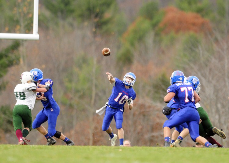 Oak Hill quarterback Dalton Therrien throws a pass against Winthrop/Monmouth during a Campbell Conference Class D semifinal game Saturday in Wales.