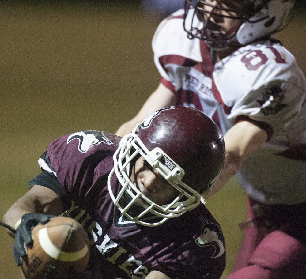 Maine Central Institute’s Willie Moss stretches the ball into the end zone as Orono’s Sam Honey defends during a Class D North semifinal game last weekend. The Huskies will host Mattanawcook on Friday night in the LTC final.