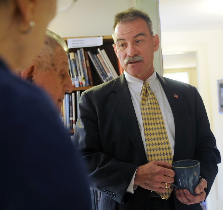 Former Assistant Secretary of State Robert Charles greets childhood neighbors on Sunday before giving a talk on international terrorism at the Cary Memorial Library’s Williams House in Wayne.