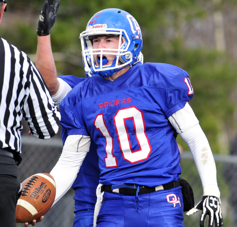 Oak Hill quarterback Dalton Therrien celebrates after scoring a touchdown during the Class D South title game against Lisbon last Saturday in Wales. The Raiders prevailed, 21-20.