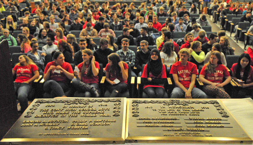 Two of the three memorial plaques are seen on stage before an assembly on Friday at Cony High School in Augusta, where a former student was honored for her efforts to honor fallen soldiers.