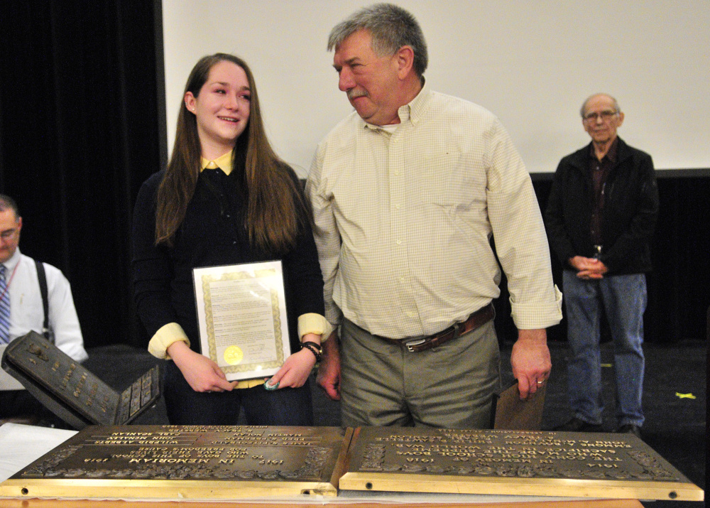 Kelsey Rohman, left, and James Wiggin were recognized for restoring memorial plaques honoring Cony High School students killed in World War I and World War II on Friday during an assembly at the school in Augusta.
