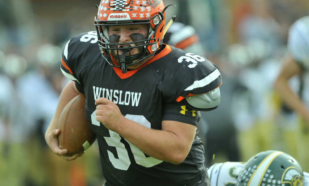 Winslow rnning back Kenny Rickard breaks through the Mt. Desert Island High School defense during a Big Ten Conference semifinal game Saturday in Winslow.