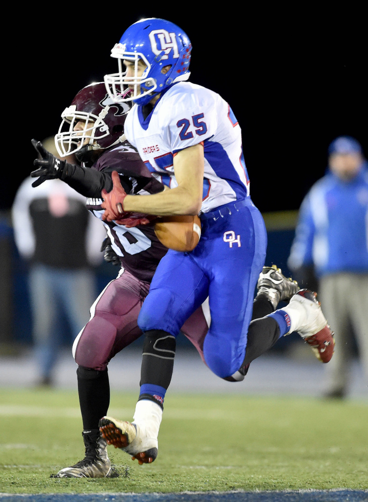 Oak Hill’s Colby Spencer (25) intercepts a pass intended for Maine Central Institute’s Braden Monteyro (198) during the Class D state championship game Friday night at Alfond Stadium in Orono.