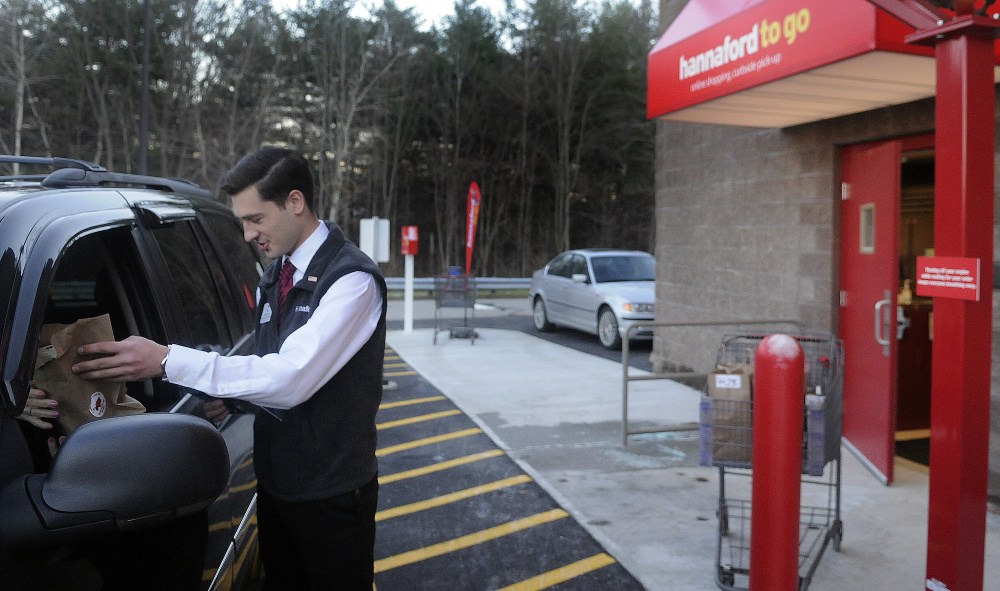 Hannaford employee Matt Pazdziorko hands customer Priscilla Zarella, of Readfield, items she ordered Monday from the Hannaford on the Whitten Road in Augusta at the new drive up delivery spot. For a $5 service fee if the order is less than $125, customers can order items and pick them up outside the store. If the order is more than $125, the service is free.