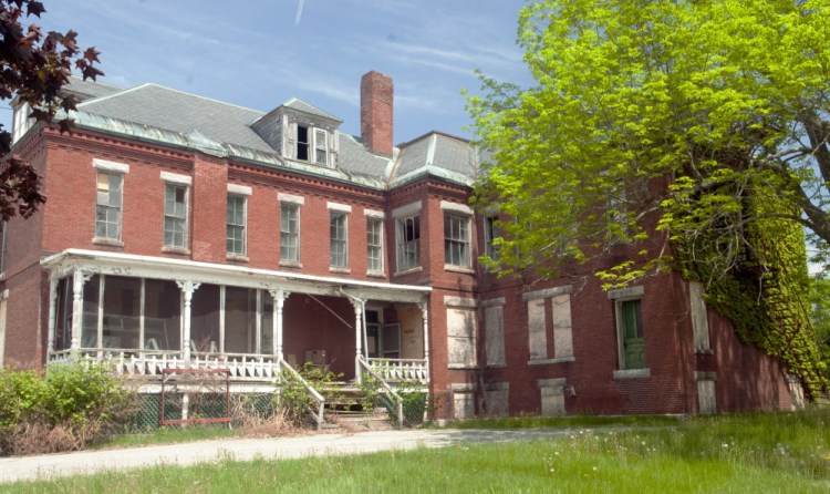 This file photo from May shows 7 Beech St. in the Stevens School complex in Hallowell, where many buildings are boarded up.