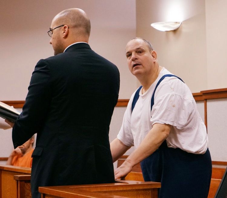 Steven Ricci, right, with his attorney, Mark Bullock, accepts new probation conditions in advance of his release from prison, in the Cumberland County Courthouse in Portland on Thursday. Photo by Scott Dolan / Staff Writer