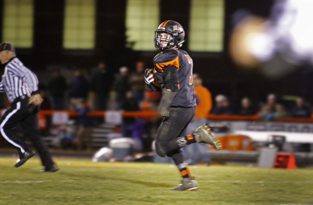 Brunswick's Jesse Devereaux looks back on his way to score a touchdown on an 84-yard run in the first half of the Dragons’ 49-0 win over Brewer in the Class B North final. Jill Brady/Staff Photographer