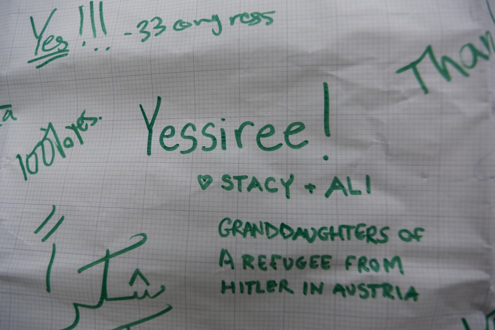 Comments on a sign posted on a Munjoy Hill home in support of Syrian refugees.