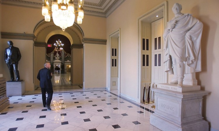 Sen. Angus King walks past the statue of long-ago Maine Gov. William King, which has stood in the U.S. Capitol since 1878, but may not stand there forever, depending on results of a survey.