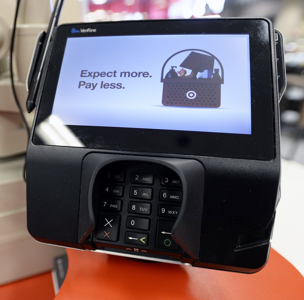 Chip-embedded payment cards, scanned by a reader like this one at Target in South Portland, are better at protecting consumers, banks and retailers from fraud and theft.