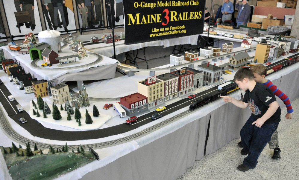 Luke Camber, 7, of Union, left, and Gunnar Everett, 6, of Morrill, watch the model trains running on Friday in the atrium outside the Maine State Museum in Augusta.