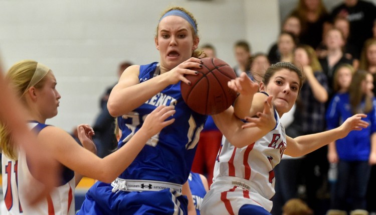 Lawrence High School’s Nia Irving (33) battles for a loose ball as Messalonskee defenders Taylor Easler, left and Sophie Holmes close in during a Class A North game Friday night in Oakland.