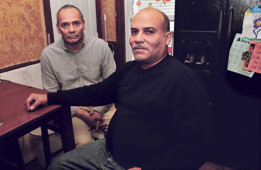Florentino Santiago, right, sits with his brother Carlos on Thursday at their apartment in Winslow. Florentino has struggled with funeral costs for two of his deceased brothers, and now Carlos has medical needs.