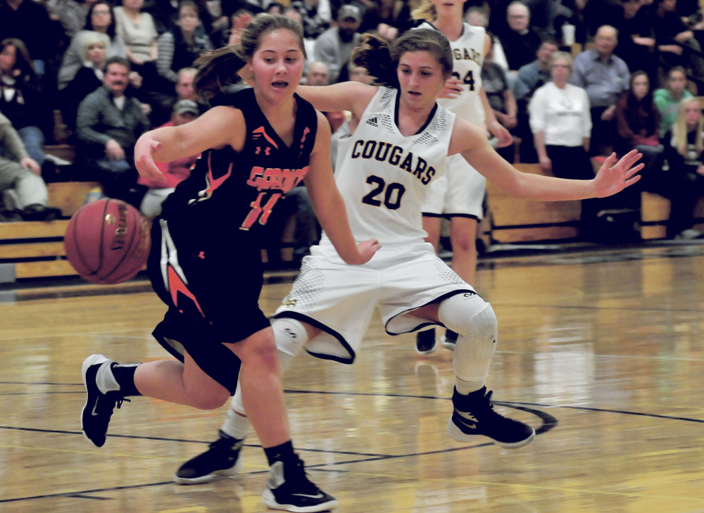 Gardiner’s Logan Granholm and Mt. Blue’s Eryn Doiron eye a loose ball during a game Tuesday night in Farmington.