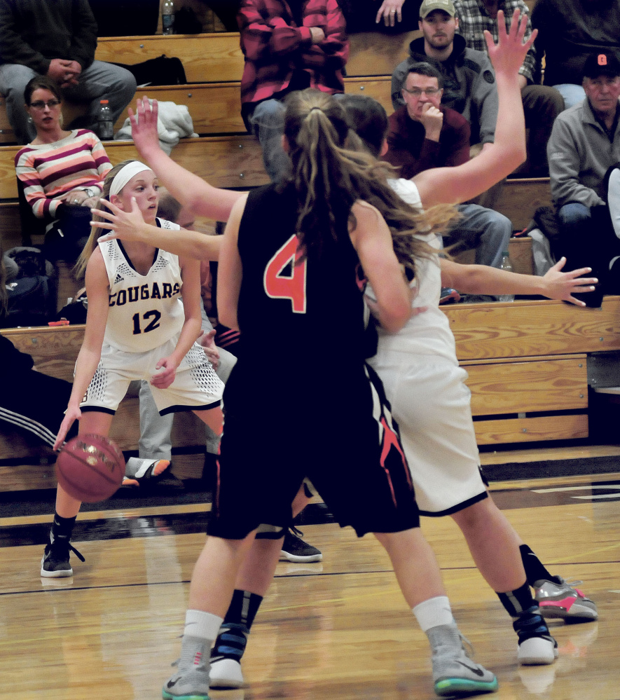 Mt. Blue’s Emilee Eustis (12) faces some pressure during a Class A North game Tuesday night against visiting Gardiner.