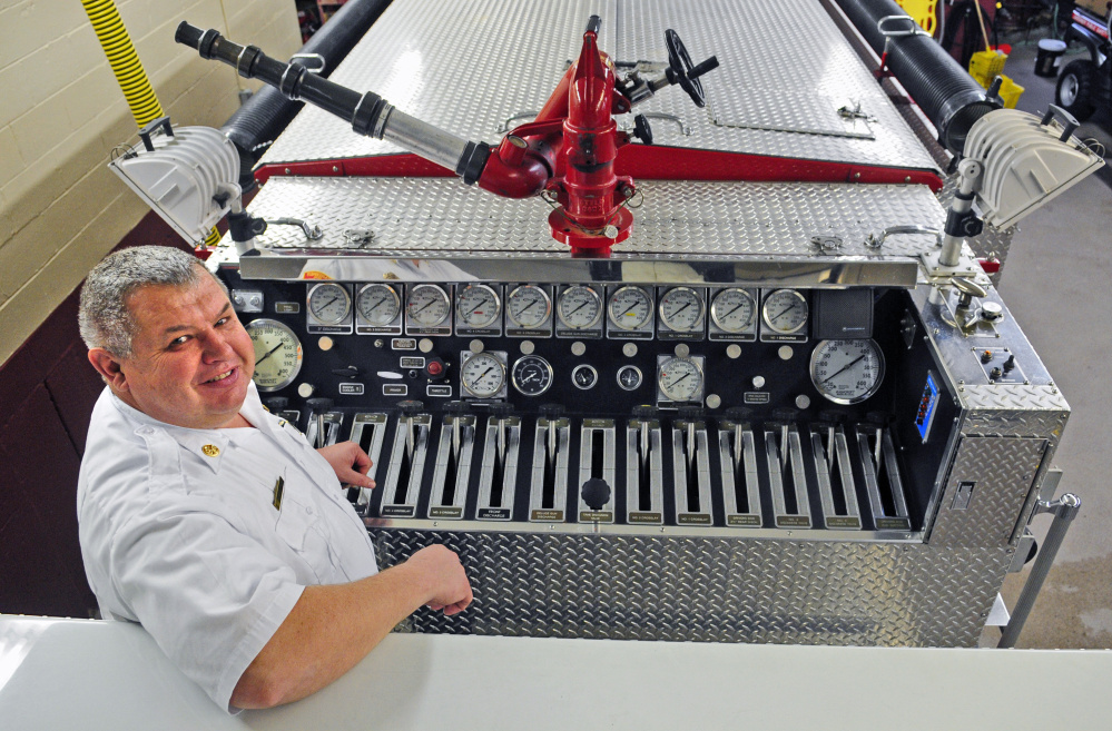 Gardiner Fire Chief Al Nelson stands near the pump controls of Gardiner Engine 1 at the Gardiner Fire Station.