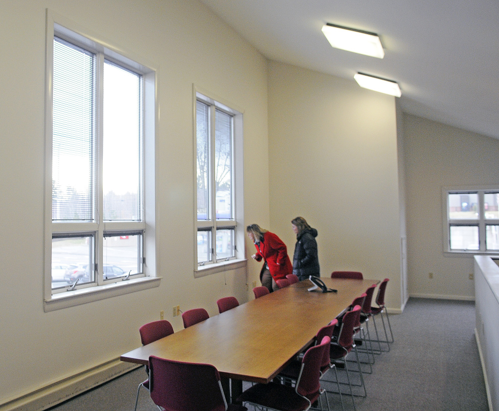 Kim Lindlof, left, and Alison Paine tour the conference room Monday at the Kennebec Valley Chamber of Commerce’s new offices on Western Avenue in Augusta. Lindlof is president & CEO of the Mid-Maine Chamber of Commerce in Waterville. Paine is an account executive at GHM Insurance Agency in Waterville.