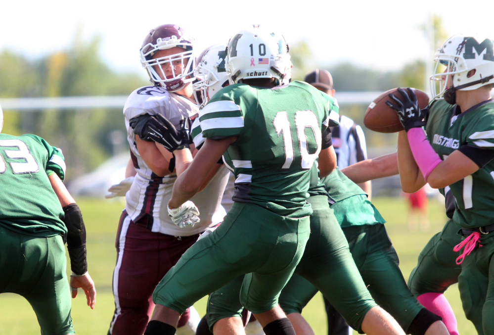 Maine Central Institute’s Curtis McLeod eyes Mount View quarterback Rayno Boivin during the third quarter of a Little Ten Conference game in Thorndike this past season.