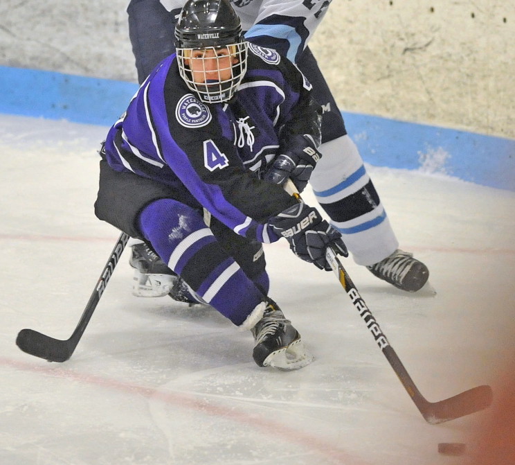 Waterville Senior High School’s Michael Oliveira (4) tries to escape Presque Isle High School’s Dennis Young in a game last season at Sukee Arena in Winslow.