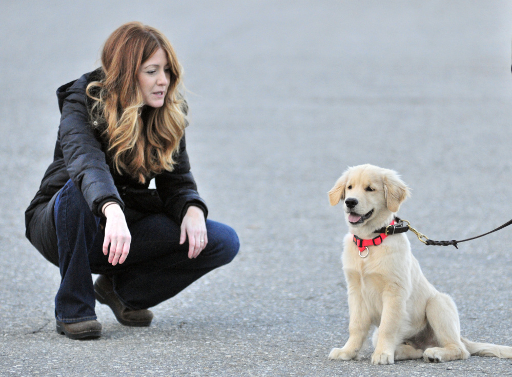 Staff file photo by Joe Phelan
AmyLou Craig, left, and her puppy Brewer on Nov. 24 in a parking lot near the Kennebec River Rail Trail in Augusta.