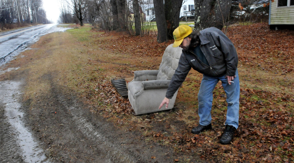 Gerry Bechard points to tire tracks made by a hit-and-run driver who struck and seriously injured Bechard’s dog Diesel. The family believes Diesel was in the yard when he was hit,