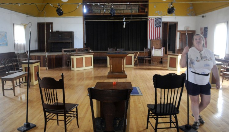 Branch Mills Grange Secretary Pam Swift holds a staff in the meeting room of the fraternal organization’s hall in Palermo in this September file photo.
