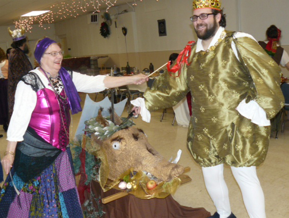 Two members of the Recycled Shakespeare Company community theater: Dale Sturtevant, left, of Oakland, and Josh Fournier, of Fairfield, fight for the boar’s head at Madcap Madrigal.