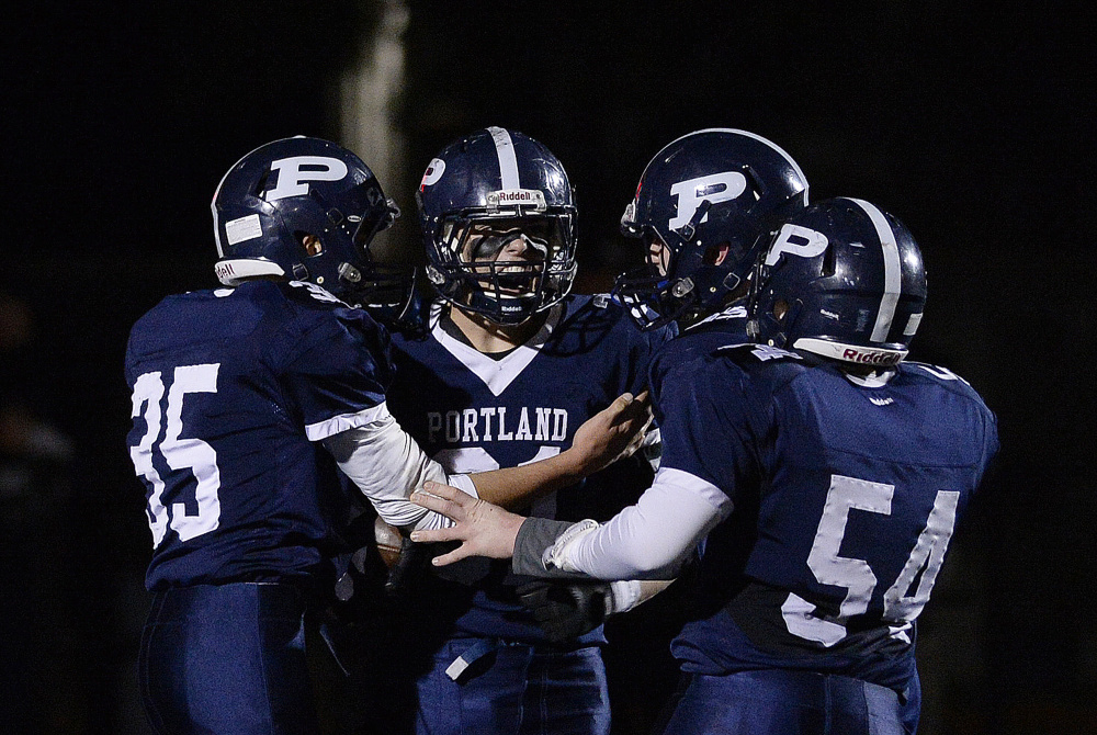 Portland’s Joseph Esposito, center, is one of three finalists for the James J. Fitzpatrick Trophy, which is awarded to the top senior high school football player in the state.