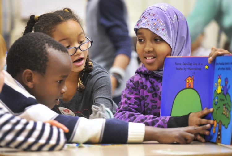 Nasra Omar, 9, a civil rights team member at Portland’s Riverton Elementary School, mentors first-graders Alpha Kabagambe, left, and Maya Fairclough.