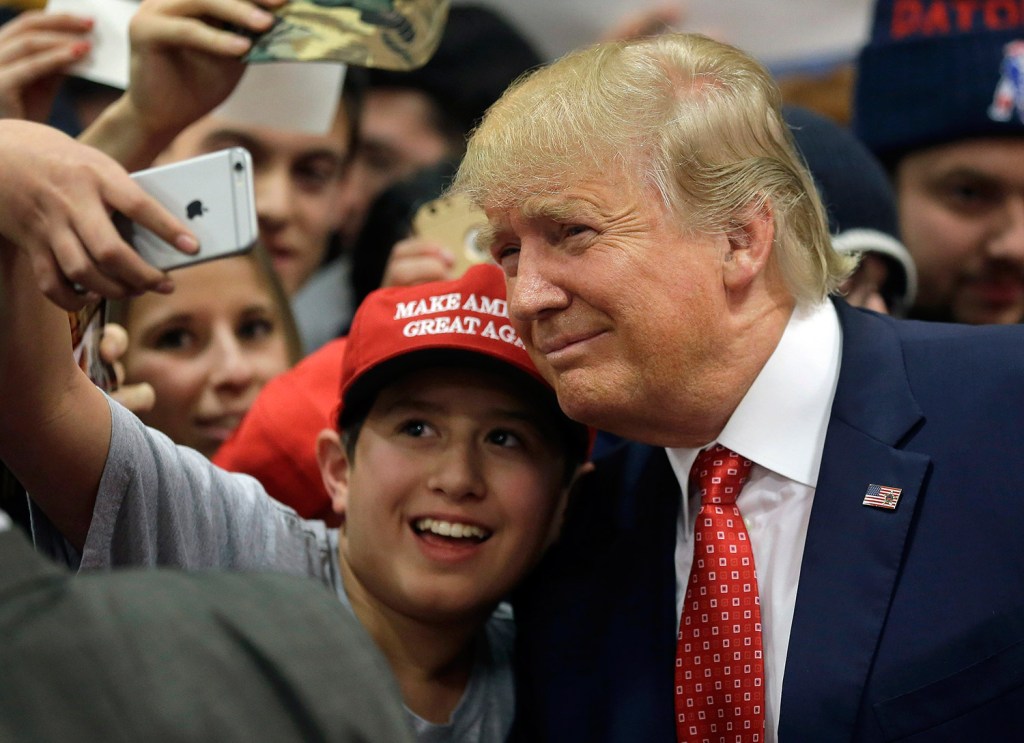 Republican presidential candidate Donald Trump poses for a photo in Nashua, N.H. Hackers in California shared their love for the candidate on a freeway sign.