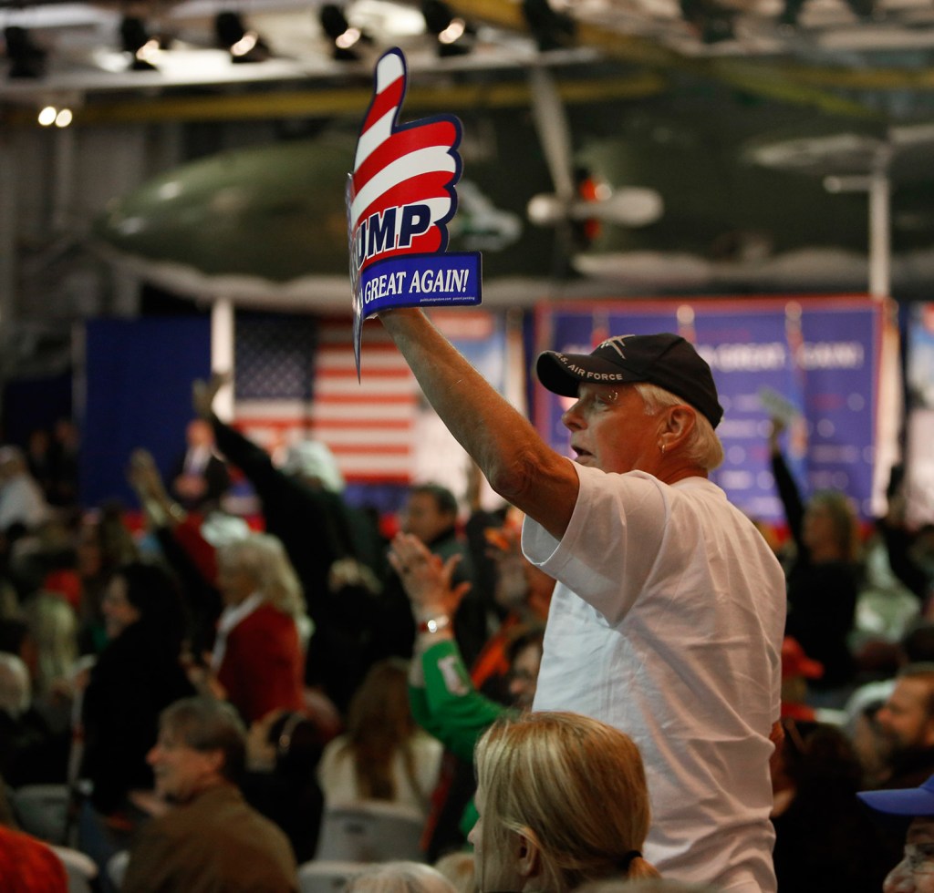 Supporters of Donald Trump wave to the press after being prodded by Trump during a rally Monday night aboard the aircraft carrier USS Yorktown in Mt. Pleasant, S.C. The crowd cheered Trump's call for a ban on Muslims entering the U.S.
The Associated Press