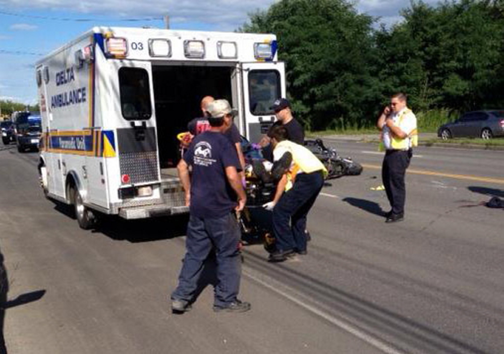 Emergency responders help James Bolduc, who was injured fatally Aug. 28, when his motorcycle collided with an SUV on College Avenue in Waterville. Bolduc, of Fairfield, was one of 32 motorcyclists to die in accidents in Maine in 2015.
