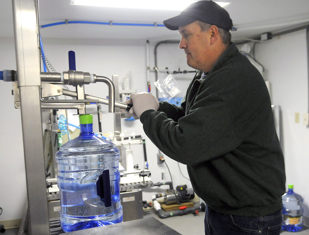 Ed Bowie caps a jug of water last week. Maine Mist was extracted from a well at his family’s Farmingdale business, the Cobbossee Beverage Shop.