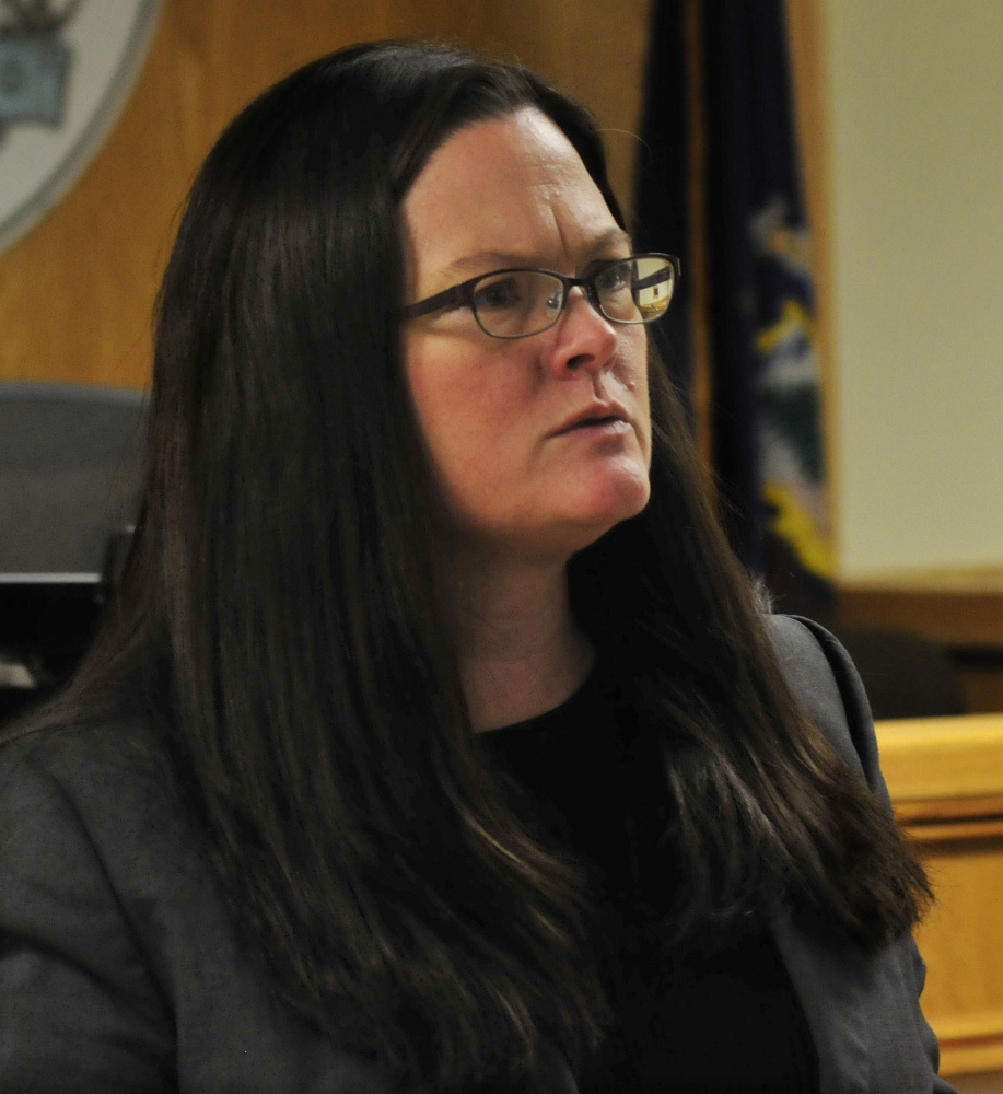 Assistant Attorney General Deborah Cashman speaks with other attorneys Monday after defendant Dana Craney pleaded guilty to killing his grandmother, Joanne Goudreau.