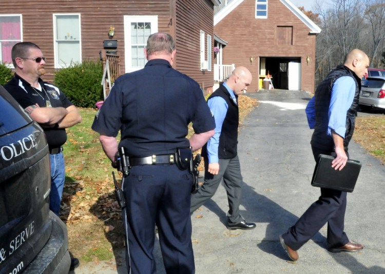 Two Maine State Police detectives, at right, investigate Nov. 5 at a Belgrade Road residence in Oakland where Herman DeRico shot and killed three adults, and then killed himself. Oakland police officers Tracy Frost, left, and Jerry Haynes stand outside the home.  (Photo by David Leaming/Staff Photographer)