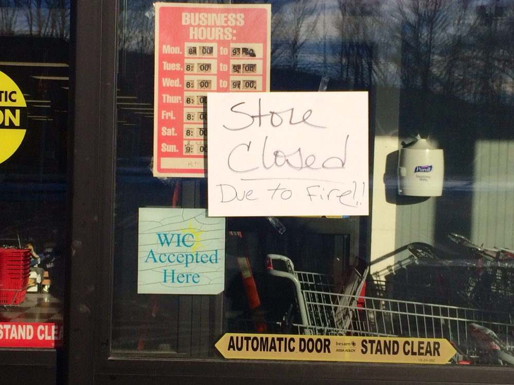 A sign on the front door of Jimmy’s Market Wednesday advises customers that the store is closed because of a late-morning fire.