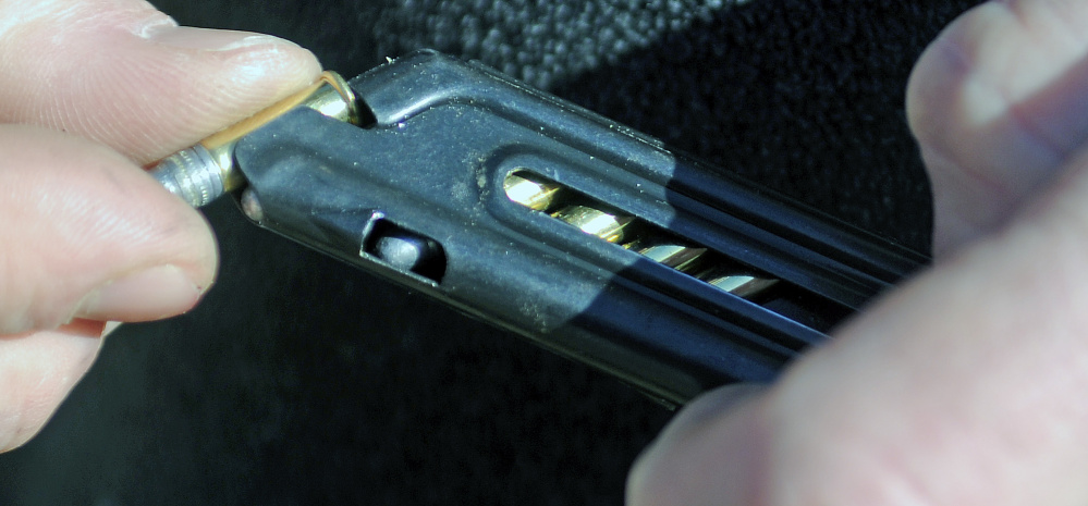 Rob Sibley packs a clip with .22 shells Wednesday at an Inland Fisheries and Wildlife range in Augusta. Sibley said he doesn’t agree with President Obama’s executive action to order more background checks on guns purchases.
