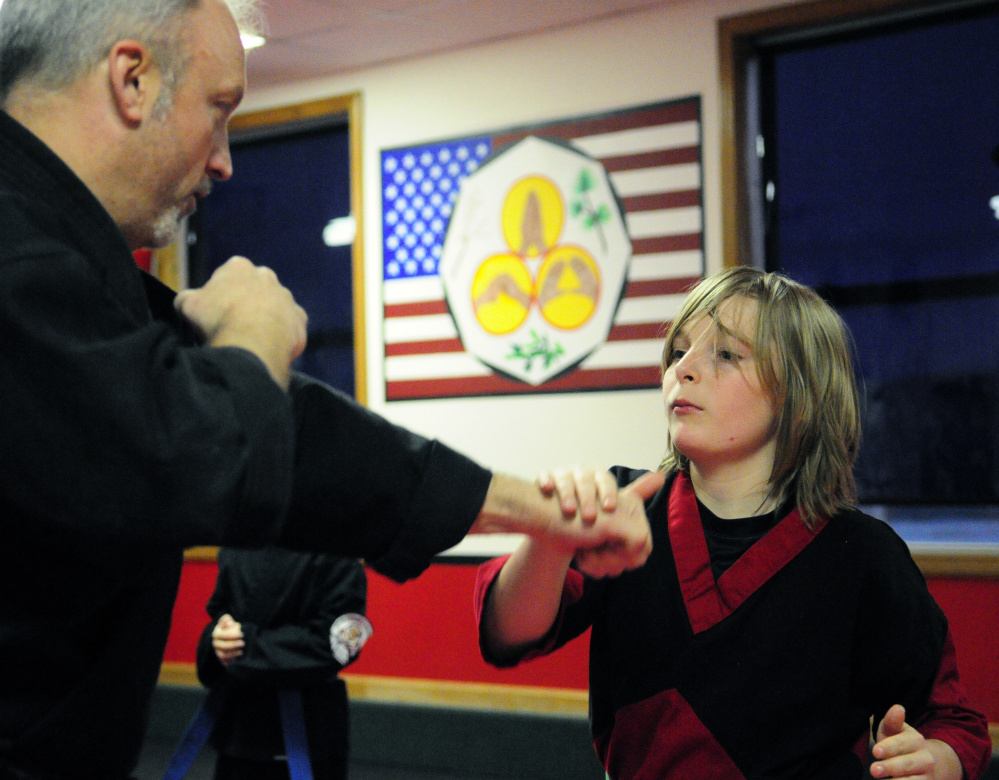 Instructor Ryan Chamberland, left, and Chase Cloutier, 12, do a drill during karate class Wednesday at United Fitness and Martial Arts in Winthrop.