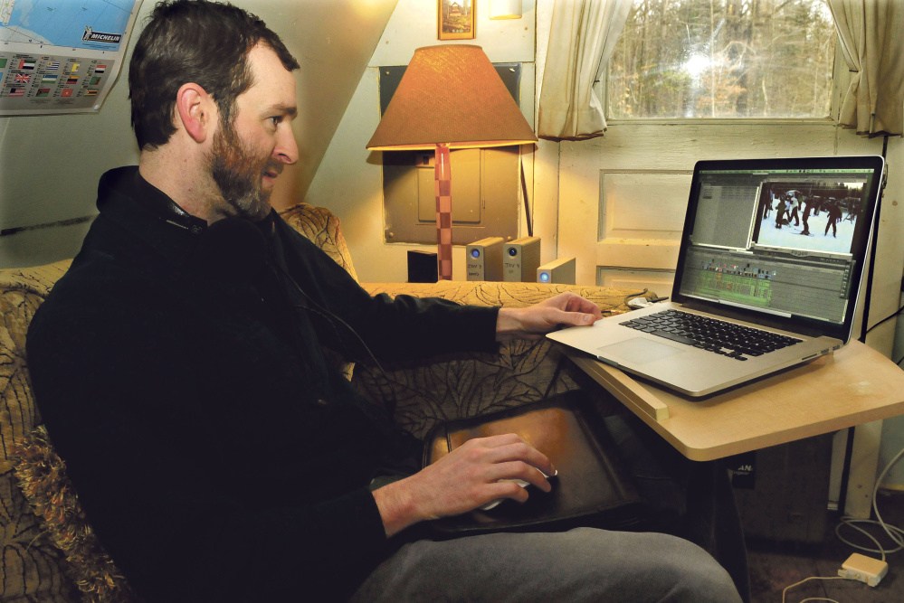 Joel Osgood works from his home in New Portland Monday. His documentary on small Maine ski resorts, “1,000 Feet & Below,” premieres at The Rack at Sugarloaf Wednesday.