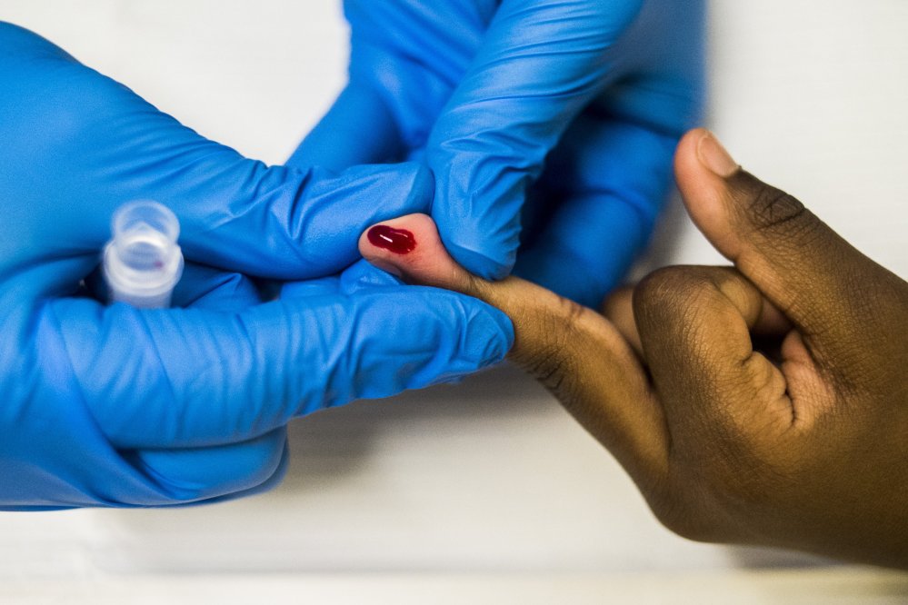 Kyaira Donald, 6, of Flint, gets her finger poked to test her blood for lead levels, while at Freeman Elementary School in Flint, Mich., Tuesday, Jan. 12, 2016. The Flint Community Schools, the Genesee County Health Department and Molina Healthcare held a family fun night at the school to get children ages 0 to 6-year-olds tested for lead levels in their blood. (Jake May/The Flint Journal-MLive.com via AP) MANDATORY CREDIT