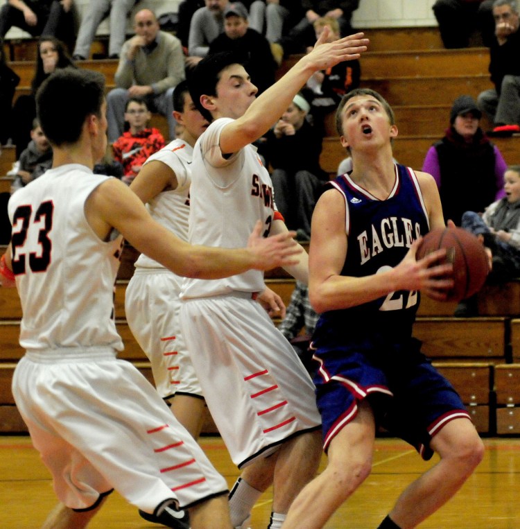 Messalonskee’s Griffin Tuttle looks to shoot as Skowhegan’s Brendan Curran (23) and Cameron Barnes apply pressure during a Kennebec Valley Athletic Conference Class A game Monday afternoon.