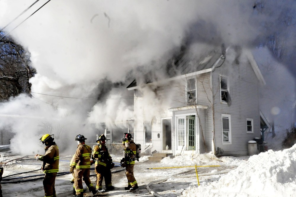Firefighters from multiple departments battle a smokey fire that destroyed a home on Water Street in Oakland on Jan. 8. The fire department is trying to get households to recognize the importance if smoke detectors and is offering free detectors for residents without them.