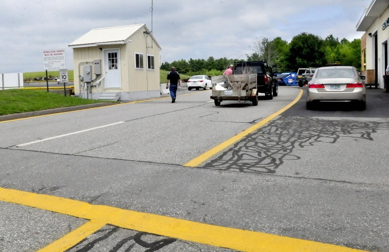 Residents arrive to drop off material of debris, recyclable items and trash at the China transfer station in July. The town is instituting a mandatory pay-per-bag system July 1 and the transfer station will only accept the designated bags after that, until a November referendum on the program.